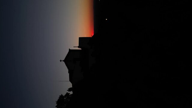 Vertical video of drone flyover Church silhouette in the sunset moody landscape, Portugal