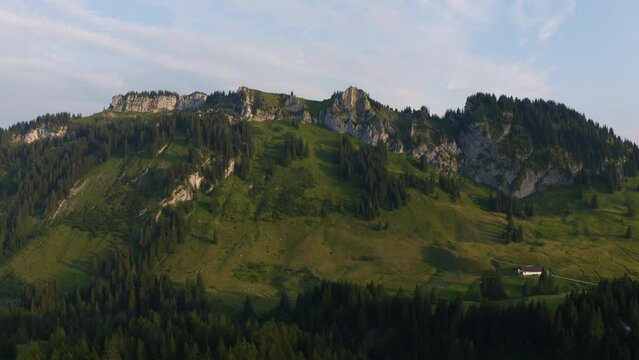 Aerial view approaching the Riedberger Horn mountain, sunny evening in Allgau, Bavaria, Germany