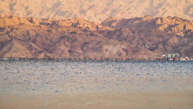 Water slowly moves in Eilat with mountains in the background