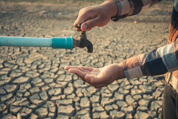 Hand for drinking water to live through drought, Concept drought and crisis environment.