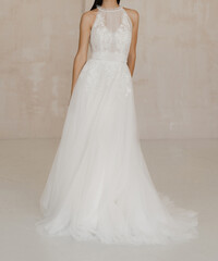 Fototapeta na wymiar Gorgeous long white sleeveless wedding dress with floral lace. The bride dressed in a white dress