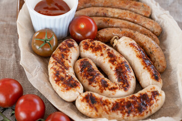 Grilled sausages with sauce and vegetables. Summer rest concept