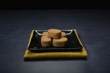 homemade Japanese western asian cookies with peanut, matcha, earl grey tea, almond green tea and icing sugar in round shape on black and gold luxury background handmade fresh bakery pastry halal menu