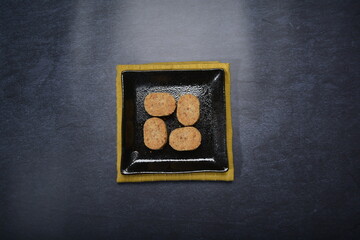 homemade Japanese western asian cookies with peanut, matcha, earl grey tea, almond green tea and icing sugar in round shape on black and gold luxury background handmade fresh bakery pastry halal menu