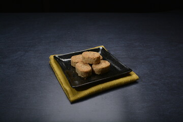 homemade Japanese western asian cookies with peanut, matcha, earl grey tea, almond green tea and icing sugar in round shape on black and gold luxury background handmade fresh bakery pastry halal menu