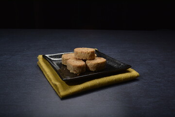 homemade Japanese western asian cookies with peanut, matcha, earl grey tea, almond green tea and icing sugar in round shape on black and gold luxury background handmade fresh bakery pastry halal menu