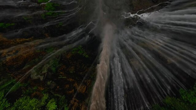 Extreme freestyle flip drone trick tropical island waterfall speed water fall stream rainforest mountain valley aerial view. FPV sport shot exotic jungle cascade fern greenery woodland cliff creek 4k
