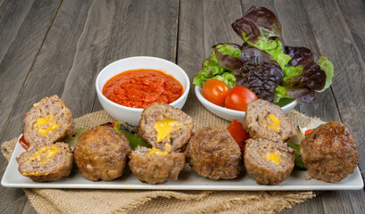 meatloaf skewers stuffed with cheddar cheese vegetables and two tomato sauces
