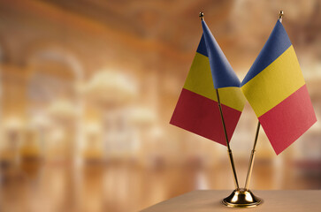 Small flags of the Romania on an abstract blurry background