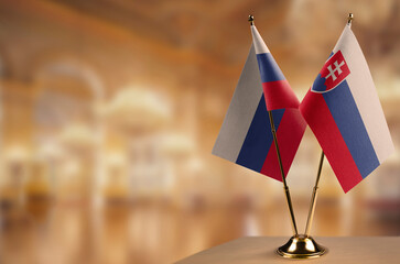 Small flags of the Slovakia on an abstract blurry background