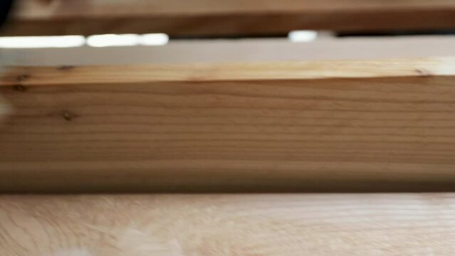 Precision in Craftsmanship A Close-Up of a Finish Carpenter Expert Hand on Natural Cedar Boards