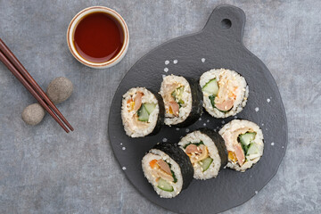 Korean Rolled Gimbap, made of rice, cucumber, tuna, carrot, sausage, crab stick and wrapped with seaweed laver. 
