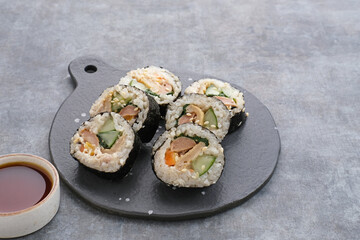 Korean Rolled Gimbap, made of rice, cucumber, tuna, carrot, sausage, crab stick and wrapped with seaweed laver. 
