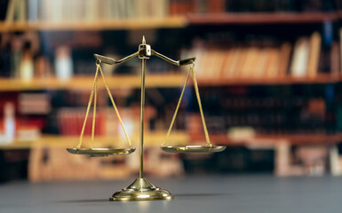 Shiny golden balanced scale in courtroom background as concept justice and a common legal symbol....