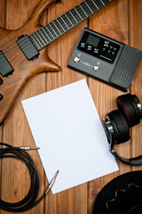 Naklejka premium Mockup with electric guitar, processor and professional studio headphones.