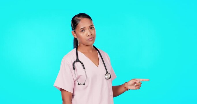 Woman, doctor and point in studio for mockup, healthcare decision or tips menu by blue background. Young female medic, pointing or portrait for disagree, mock up space or advice for bad health habits