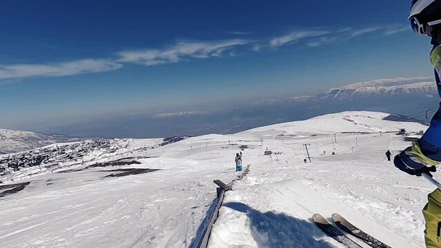 Jumping skier at jump inhigh mountains at sunny day