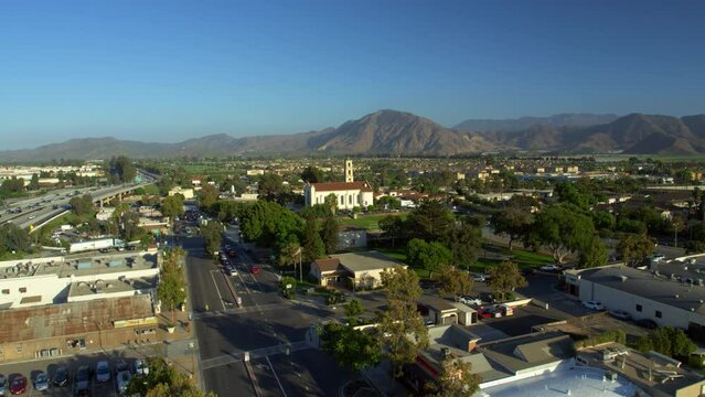 Aerial Forward Shot Of Cross Symbol On Catholic Church In City Against Clear Sky - Camarillo, California