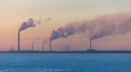 Smoke from the chimneys of a metal plant against the sky. Production.