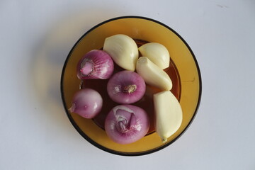 peeled onion and garlic, on a white background