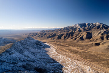Snow in Mountains of California. Aerial view on cactus with snow during last winter days.