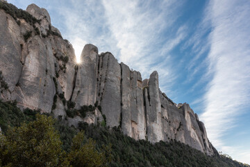 Fototapeta na wymiar Sun sets behind cliffs of Montserrat in Spain