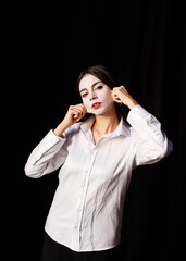 Young actress in a costume with white make-up in the rehearsal theater