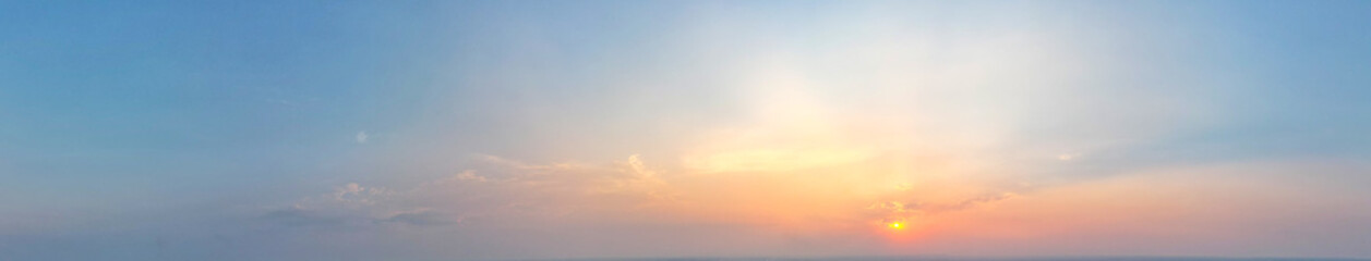 Obraz premium The panoramic view of the beautiful orange cloud with sunset light blue sky was a perfect moment of tranquility and peace, Sky background.