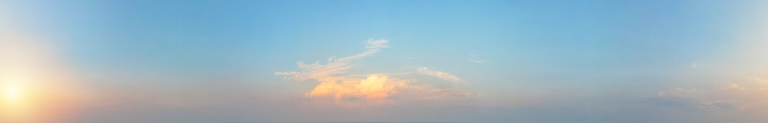 The orange cloud in the panorama provided a stunning contrast against the blue sky tinted with sunset light, Sky background.