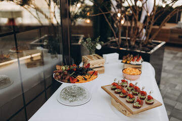 table setting for dinner with fruit on the summer terrace