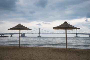 Gwangalli Beach and Gwangan Bridge in Busan during winter morning cloudy day at Suyeong-gu , Busan  South Korea : 9 February 2023