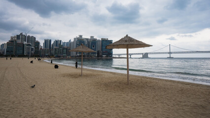 Gwangalli Beach and Gwangan Bridge in Busan during winter morning cloudy day at Suyeong-gu , Busan  South Korea : 9 February 2023