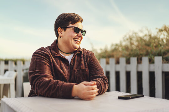 Non-binary Plus Size Woman Enjoying Time at Outdoor Cafe - Powered by Adobe