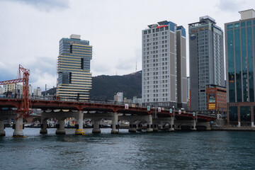 Fototapeta premium Busan Sea Port and Yeongdo Bridge during winter evening cloudy day at Jung-gu , Busan South Korea : 9 February 2023