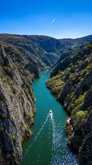 Fototapeta na wymiar Boat trip on Canyon, blue water, caves, mountains
