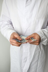 Euro banknotes in doctor's hands