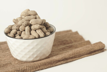 This high-quality image showcases perfectly roasted peanuts isolated on a clean white background, perfect for your food-related projects or blogs