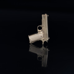 golden pistol on a black background