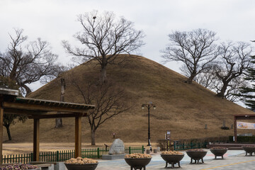 Bonghwangdae Seobongchong tombs during winter afternoon cloudy day at Gyeongju , South Korea : 10 February 2023