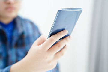 Asian teenage using mobile application in digital smartphone technology for learning.