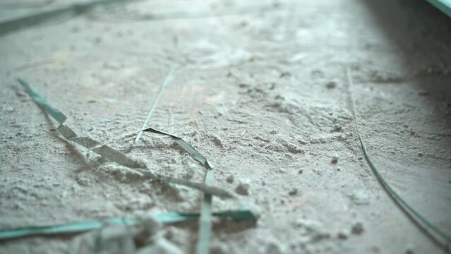 Gypsum dust on the floor after the installation of drywall walls close-up, smooth camera movement. Construction dust and debris after builders