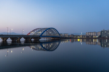 Fototapeta na wymiar Chuncheon view of Soyang 2 bridge over Soyang river during winter evening and night at Chuncheon , South Korea : 11 February 2023