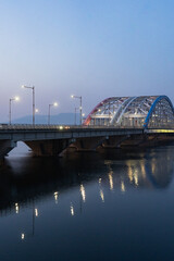 Obraz premium Chuncheon view of Soyang 2 bridge over Soyang river during winter evening and night at Chuncheon , South Korea : 11 February 2023