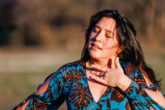Close-up of woman dancing flamenco with hand to heart