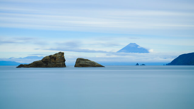 Long exposure shot of sea stacks in the water and Mount Fuji