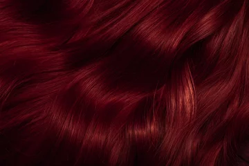 Fotobehang Dark red hair close-up as a background. Women's long brown hair. Beautifully styled wavy shiny curls. Coloring hair with bright shades. Hairdressing procedures, extension. © Vera