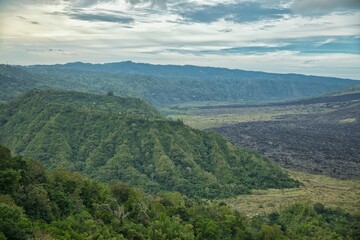 Epic view over the imposing landscape of the north of Bali in Indonesia, with its majestic mountains and green hills.