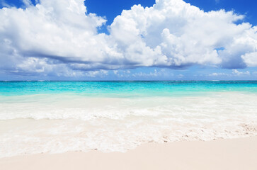 Landscape view of beautiful tropical white sand beach and turquoise sea in sunny day in Punta Cana, Dominican Republic.