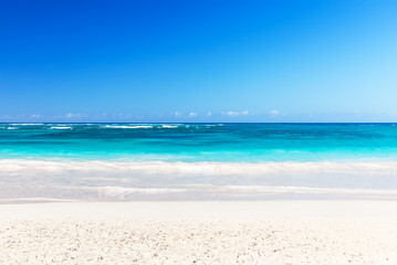 Landscape view of beautiful tropical white sand beach and turquoise sea in sunny day in Punta Cana, Dominican Republic.