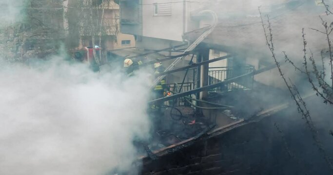 Skopje, Macedonia - 12 Apr, 2021: Firemen in action on burning ruins of building